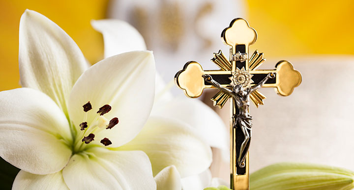 gold Jesus cross and white flower